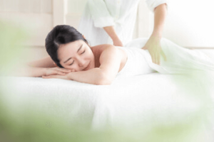 女性クライアントの腰をマッサージしている画像 腰のマッサージ